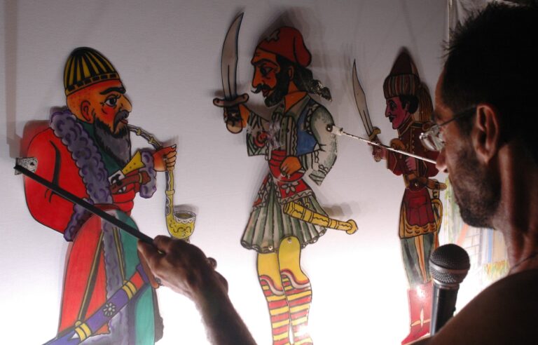 The shadow puppeteer Kostas Makris performing at the 3rd International Shadow Theatre Festival, Patras, 2005 (Archive of the Cultural Organization of the Municipality of Patras)